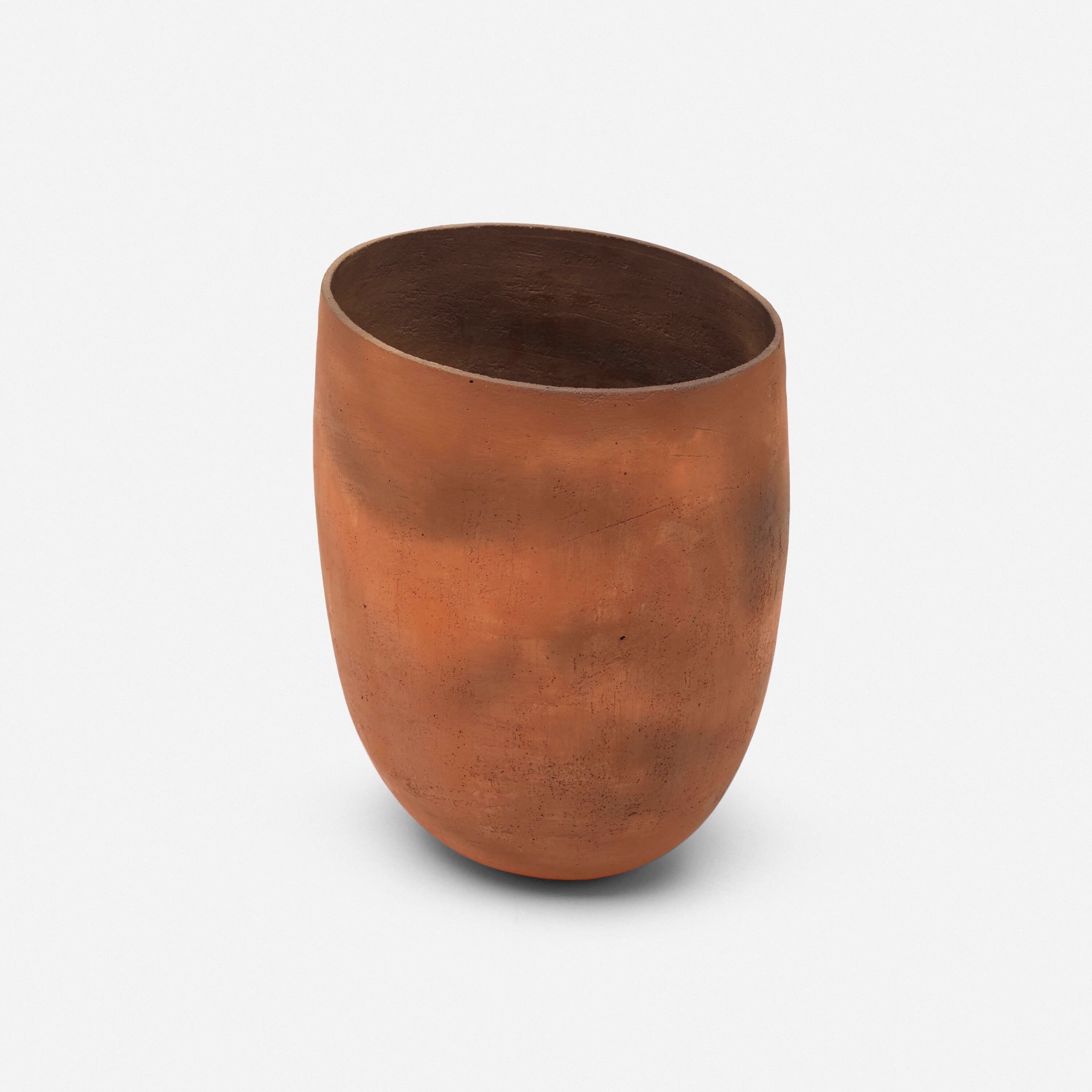 Rust-colored metal vase on a white background