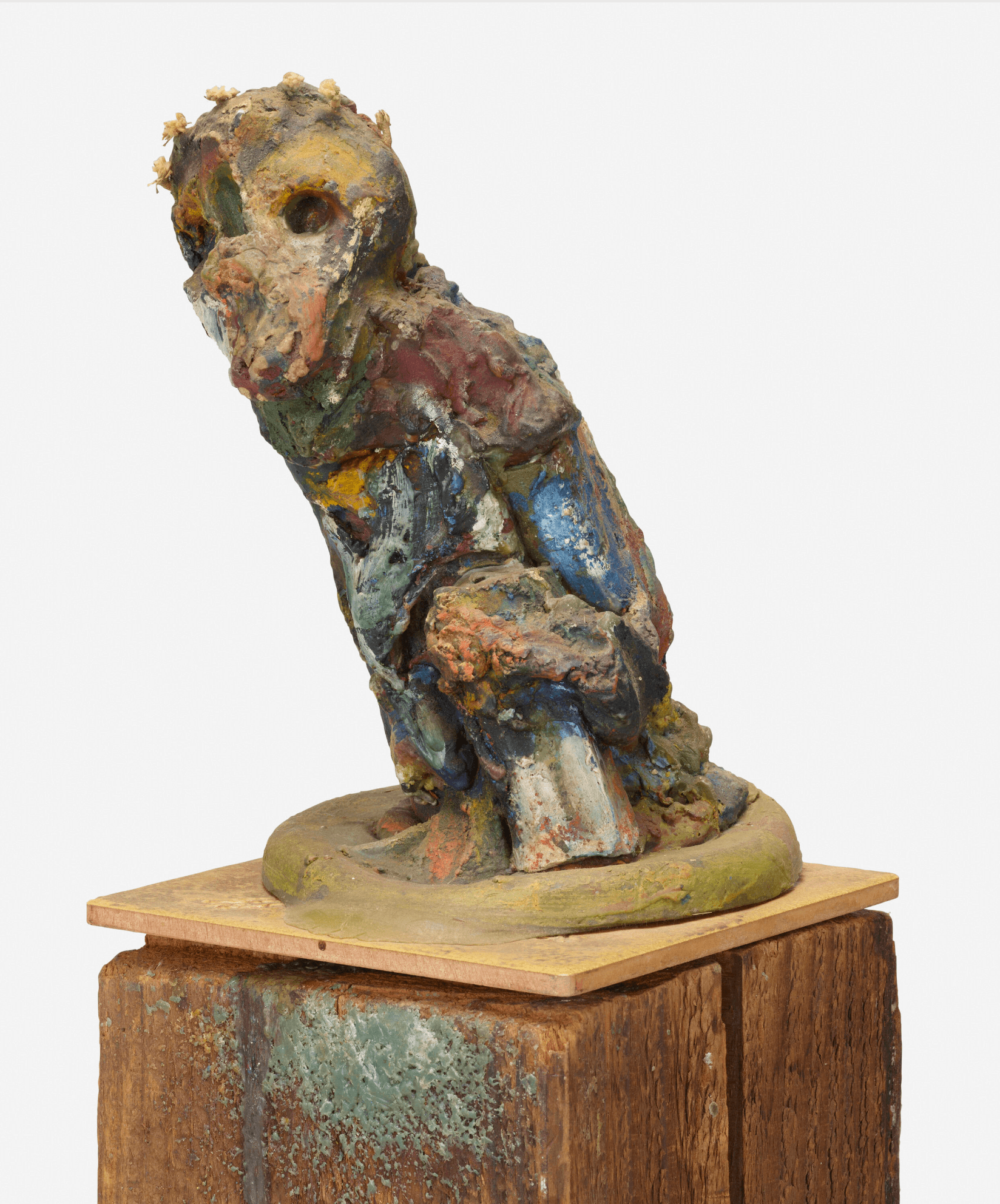 multi colored mixed media abstract sculpture of a monkey close up on pedestal